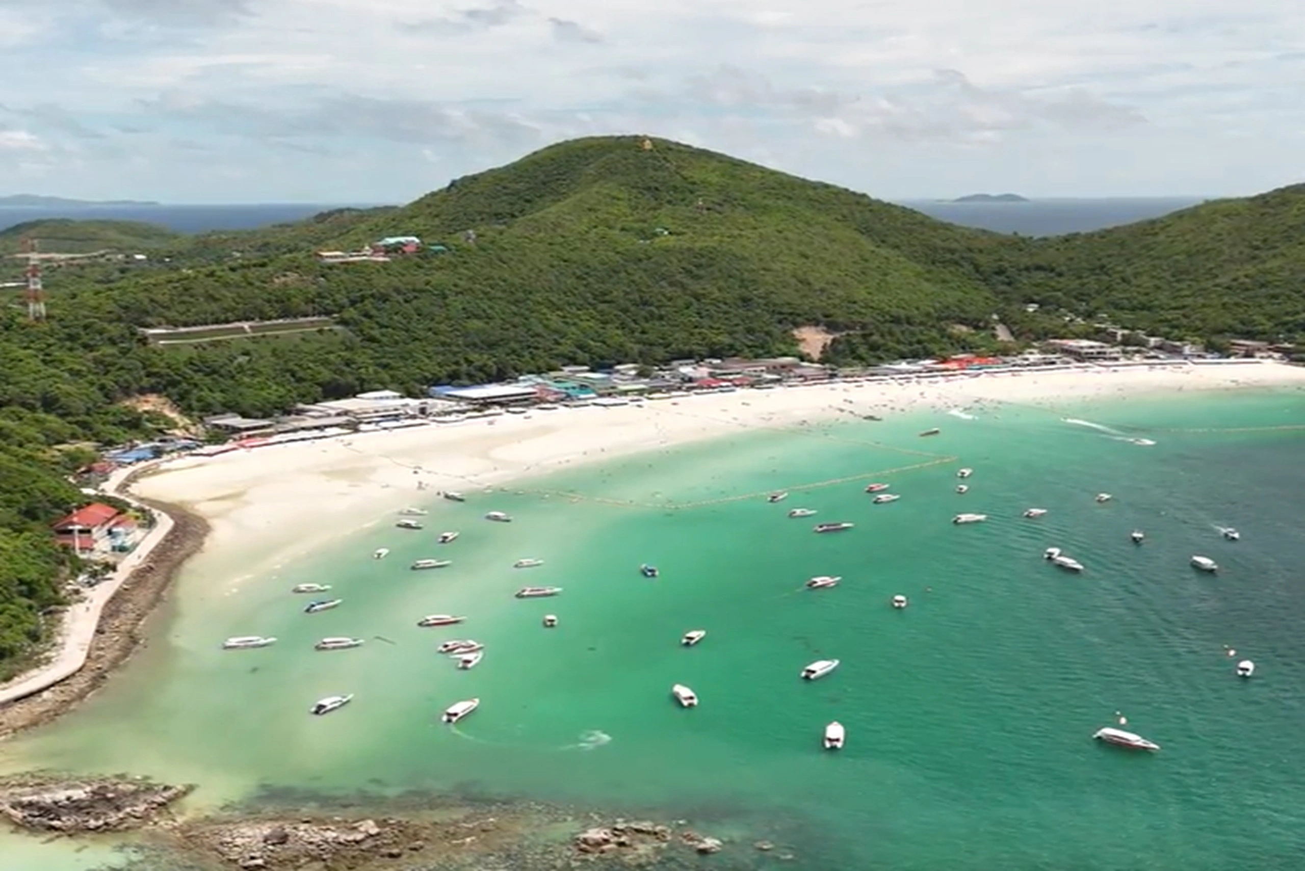 A high-speed boat arriving at the shores of Coral Island Pattaya, providing a quick 20-minute transfer for tourists.
